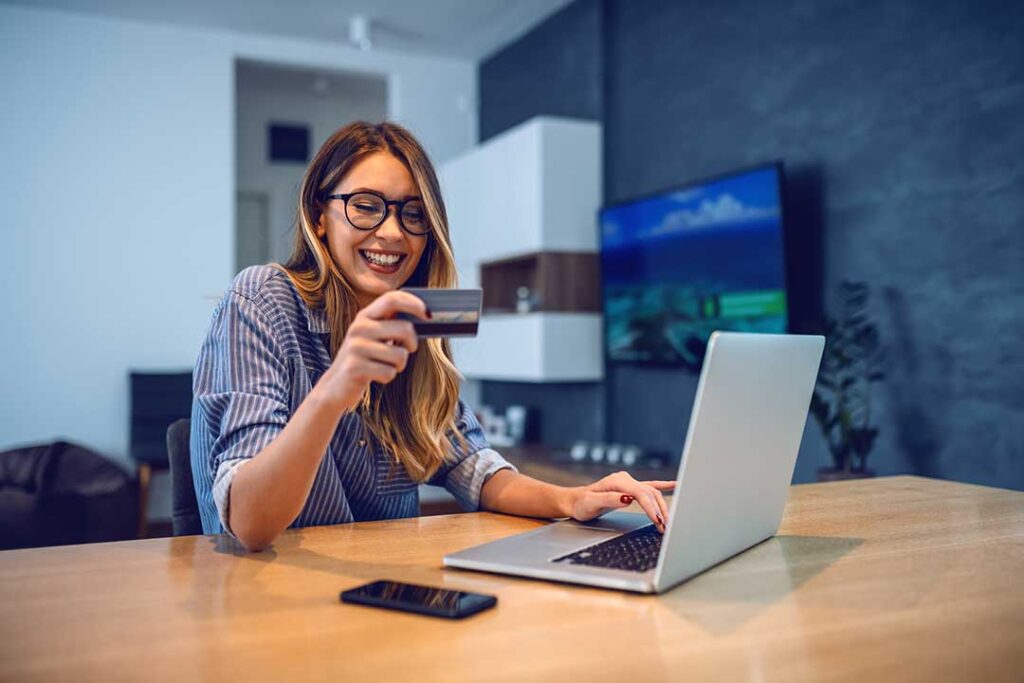 A couple reviews household finances, savings, debts, and insurance documents at a kitchen table.